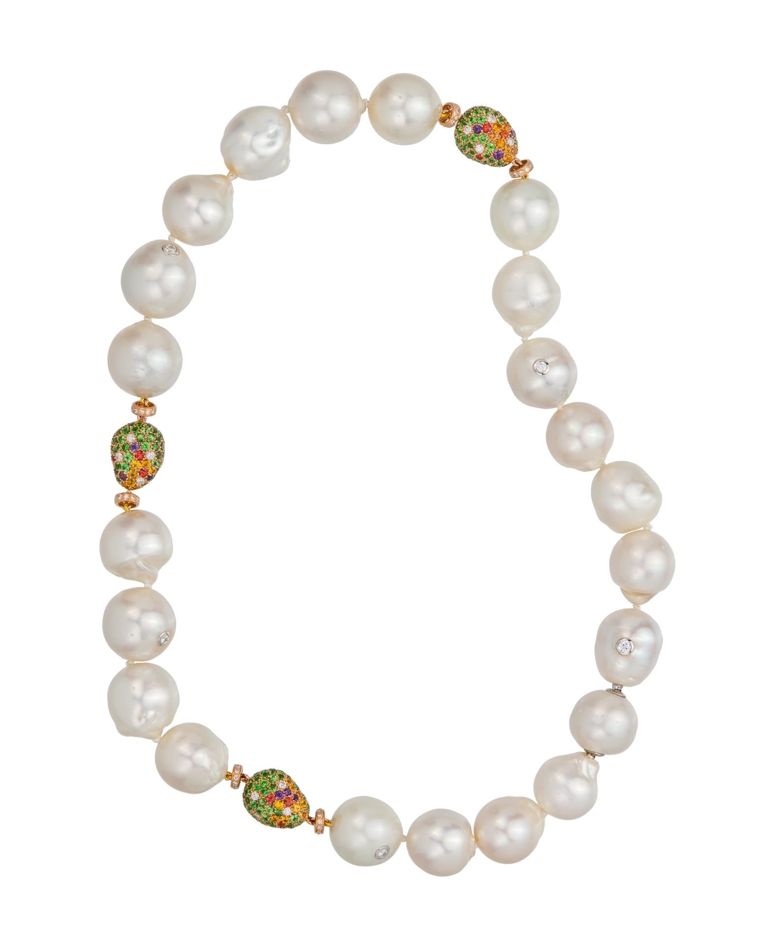 Australian South Sea pearl strand with three 'pebbles' pave set with a myriad of gemstones and a hidden bayonet clasp, crafted in 18 karat rose gold.